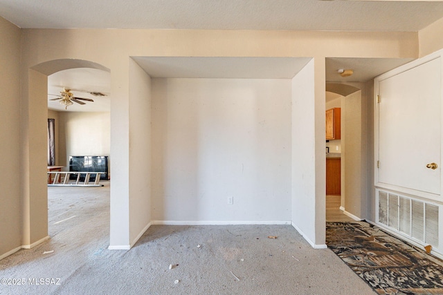 spare room featuring light colored carpet and ceiling fan