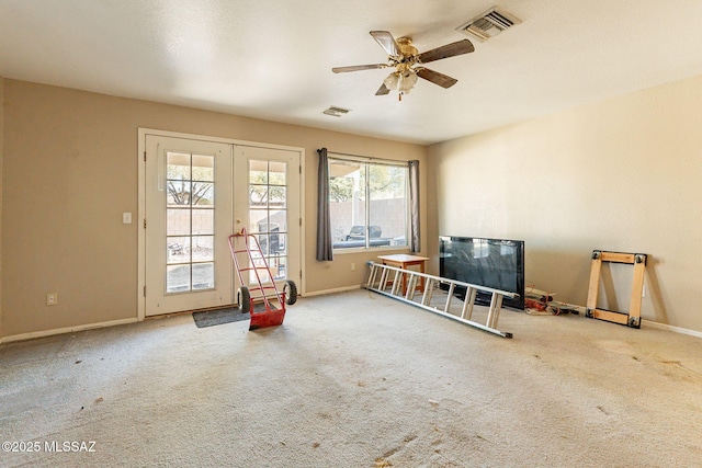 carpeted empty room with french doors and ceiling fan