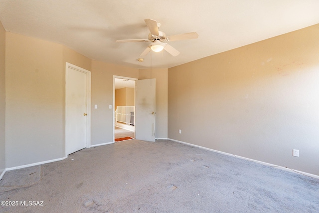 unfurnished room with light colored carpet and ceiling fan