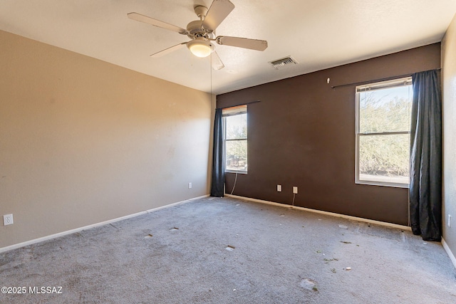 carpeted empty room featuring ceiling fan