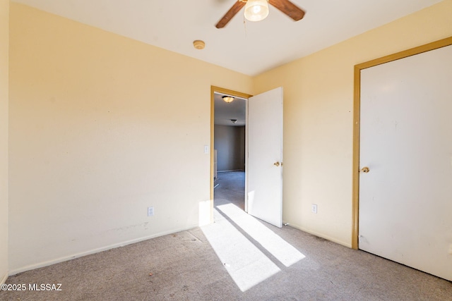 unfurnished bedroom featuring light carpet and ceiling fan