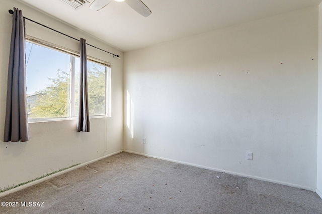 spare room featuring ceiling fan and light carpet