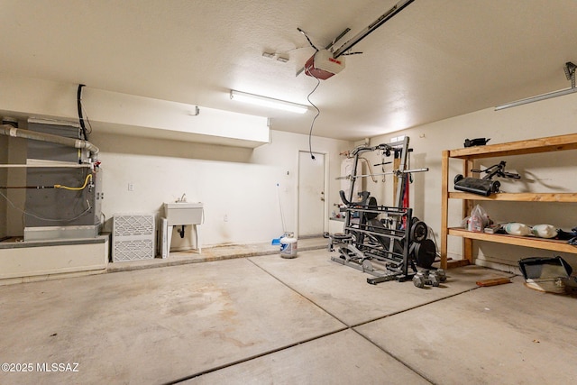 garage with sink and a garage door opener