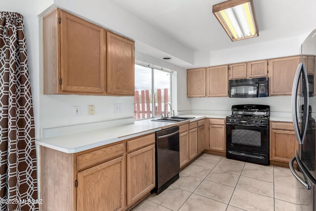 kitchen with sink, light tile patterned floors, and black appliances