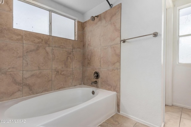 bathroom with tile patterned floors and shower / washtub combination