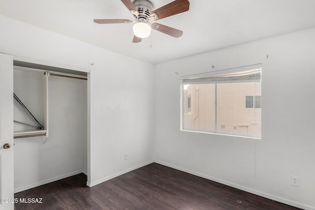 unfurnished bedroom with dark wood-type flooring, ceiling fan, and a closet