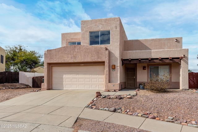 pueblo-style home with a garage