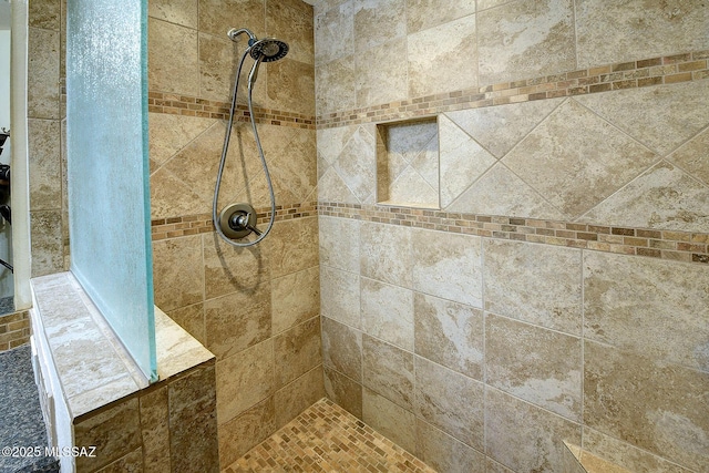 bathroom with a tile shower