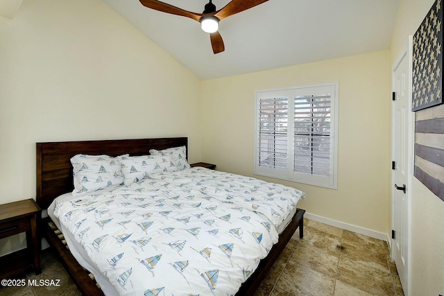 bedroom featuring vaulted ceiling, baseboards, and ceiling fan