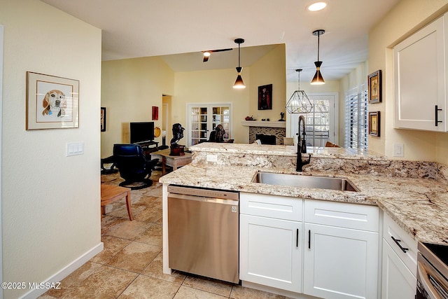 kitchen with a sink, white cabinets, open floor plan, dishwasher, and decorative light fixtures