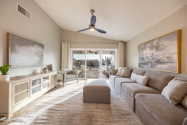 living room featuring ceiling fan and vaulted ceiling