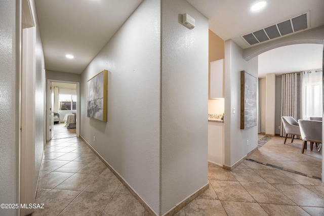 hallway featuring light tile patterned floors