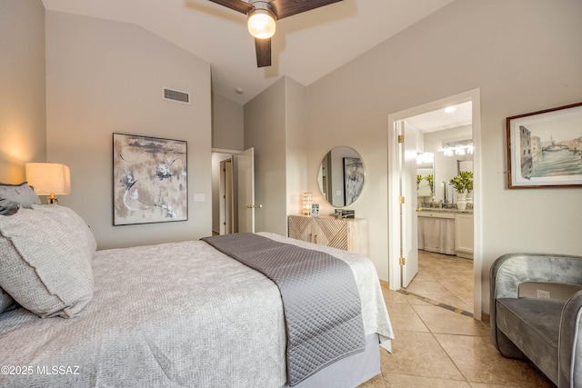 bedroom with lofted ceiling, light tile patterned floors, ceiling fan, and ensuite bathroom