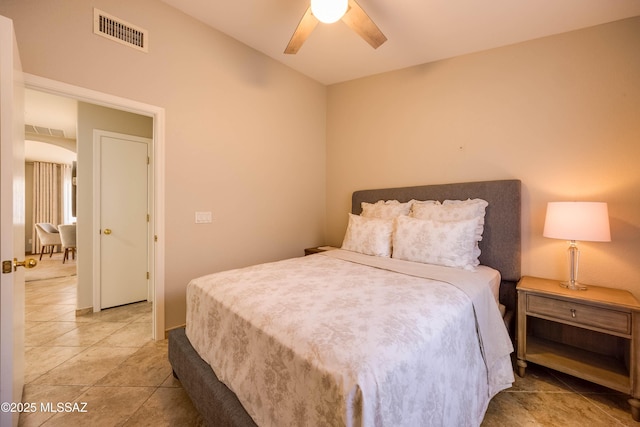 tiled bedroom featuring ceiling fan