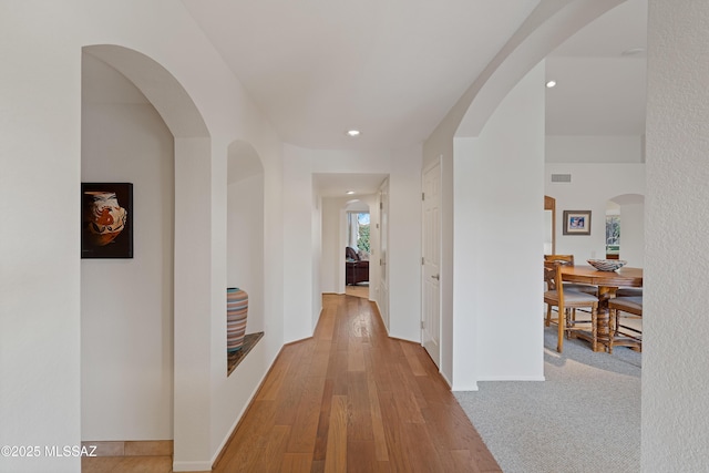 hallway with light hardwood / wood-style flooring