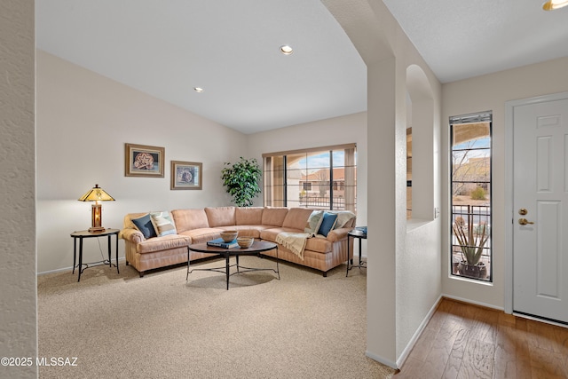 living room featuring lofted ceiling and hardwood / wood-style floors