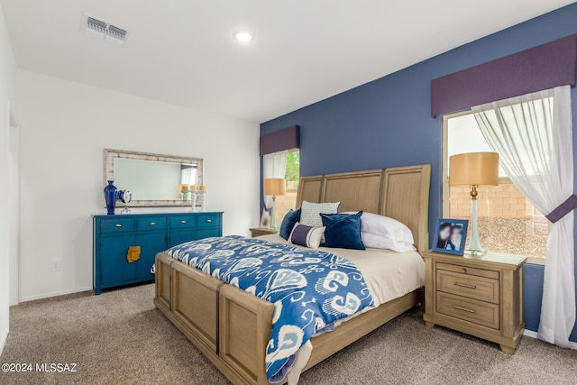 bedroom featuring light carpet