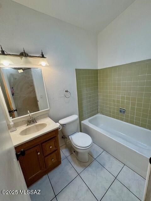 bathroom with vanity, toilet, and tile patterned flooring