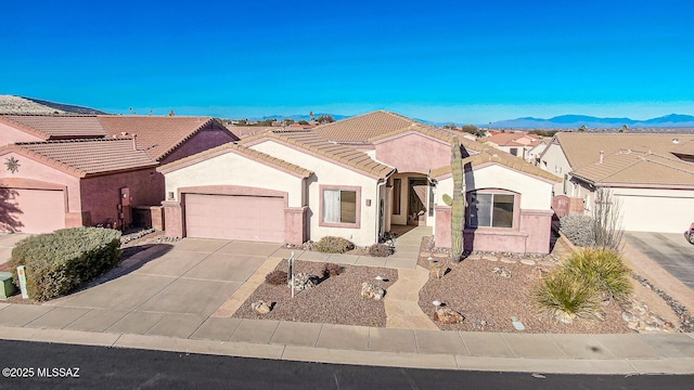 view of front of property with a mountain view and a garage