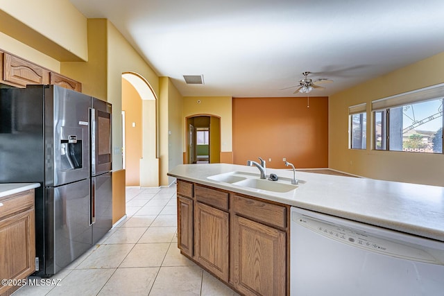 kitchen featuring refrigerator with ice dispenser, sink, ceiling fan, white dishwasher, and light tile patterned flooring