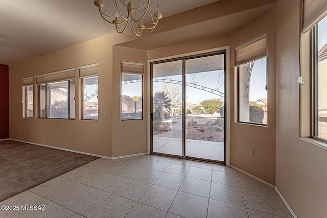 doorway featuring a notable chandelier and light tile patterned floors