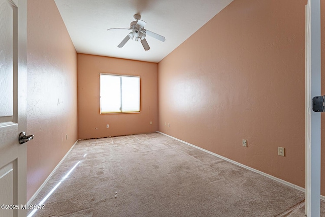 empty room with ceiling fan and light carpet