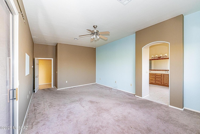 carpeted empty room featuring ceiling fan