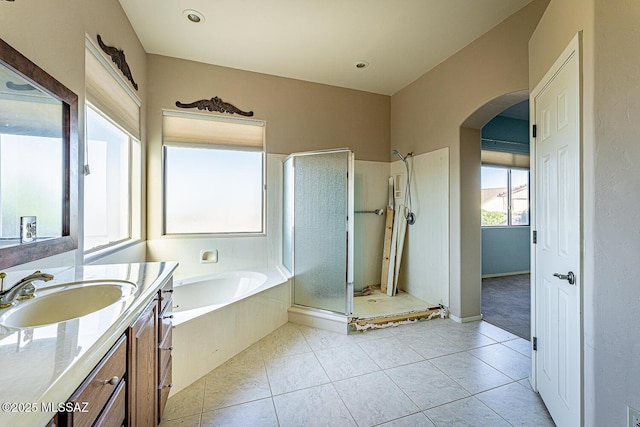 bathroom featuring vanity, tile patterned floors, and shower with separate bathtub