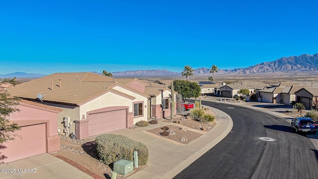 view of front of property featuring a garage and a mountain view