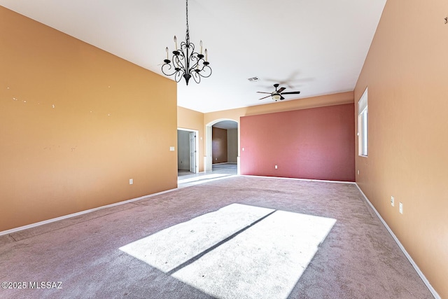 empty room with ceiling fan with notable chandelier and light colored carpet