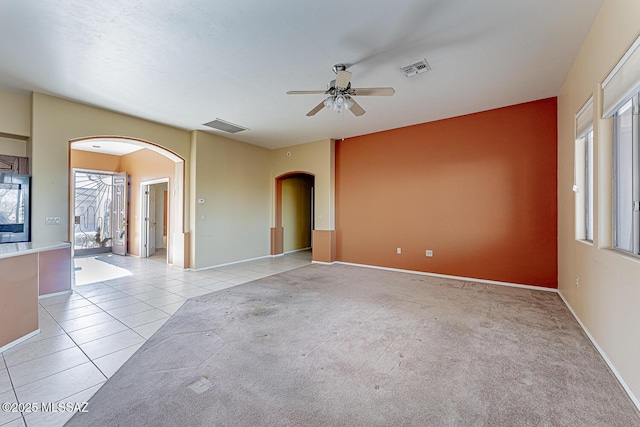 empty room with light tile patterned flooring and ceiling fan