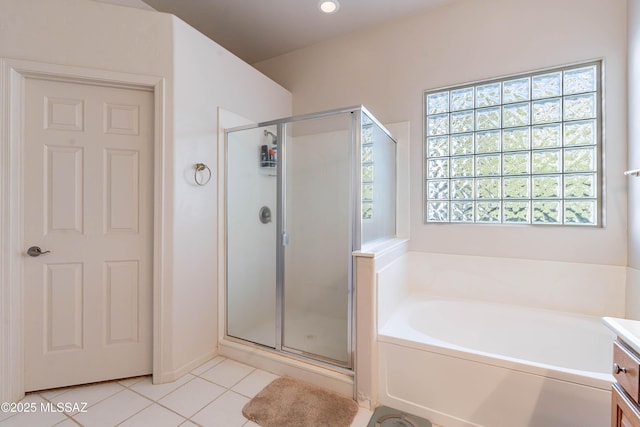 bathroom featuring vanity, tile patterned flooring, and separate shower and tub