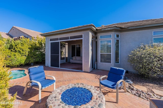 view of patio / terrace featuring a sunroom