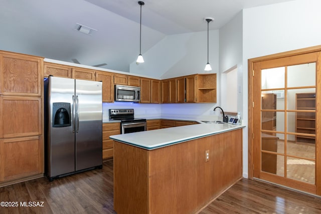 kitchen featuring sink, hanging light fixtures, stainless steel appliances, dark hardwood / wood-style flooring, and kitchen peninsula