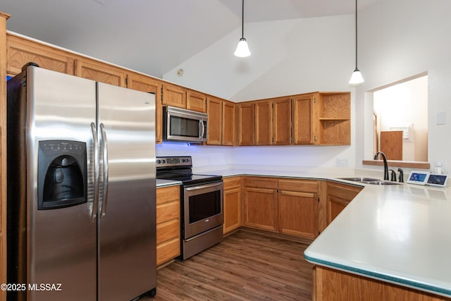 kitchen featuring appliances with stainless steel finishes, sink, lofted ceiling, and decorative light fixtures