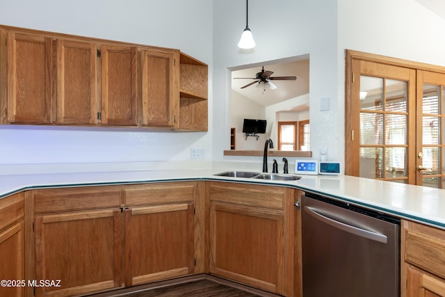 kitchen with sink, decorative light fixtures, vaulted ceiling, dishwasher, and kitchen peninsula