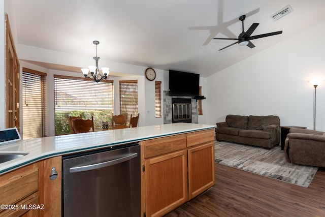 kitchen with pendant lighting, dishwasher, lofted ceiling, sink, and dark wood-type flooring