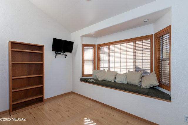 unfurnished room with hardwood / wood-style flooring and vaulted ceiling