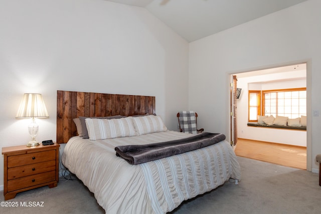 bedroom with lofted ceiling and carpet flooring