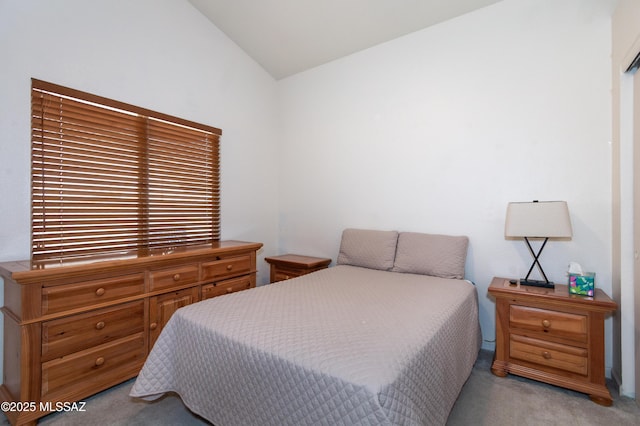 bedroom with light carpet and vaulted ceiling