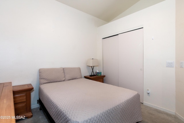 bedroom with carpet flooring, vaulted ceiling, and a closet