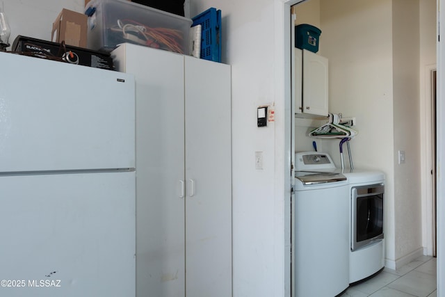 laundry room featuring cabinets and washer and dryer