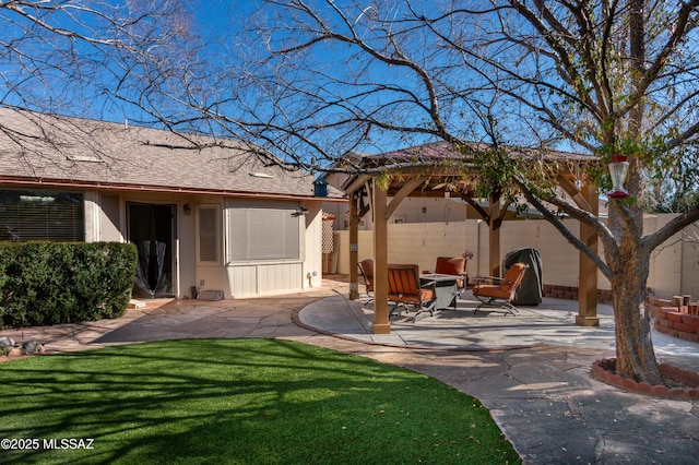 rear view of house with a lawn, a gazebo, a patio, and an outdoor fire pit