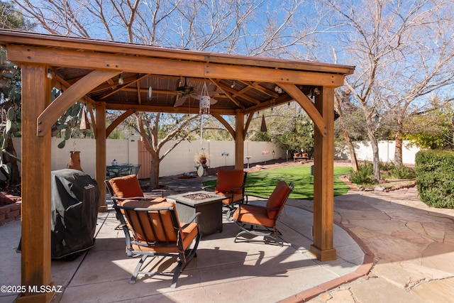 view of patio / terrace with a gazebo, ceiling fan, an outdoor fire pit, and a grill