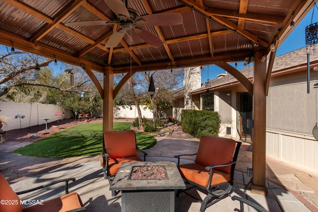 view of patio with a gazebo, ceiling fan, and an outdoor fire pit