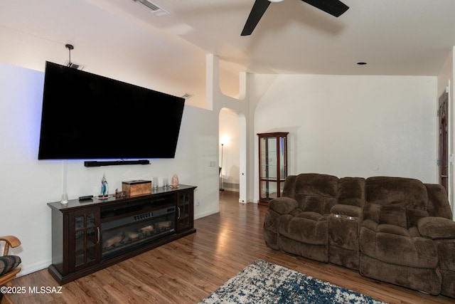 living room with hardwood / wood-style flooring, vaulted ceiling, and ceiling fan