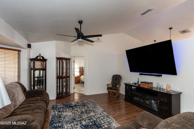 living room featuring vaulted ceiling, ceiling fan, and dark hardwood / wood-style flooring