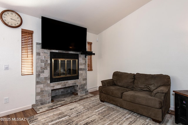 living room featuring lofted ceiling and hardwood / wood-style flooring