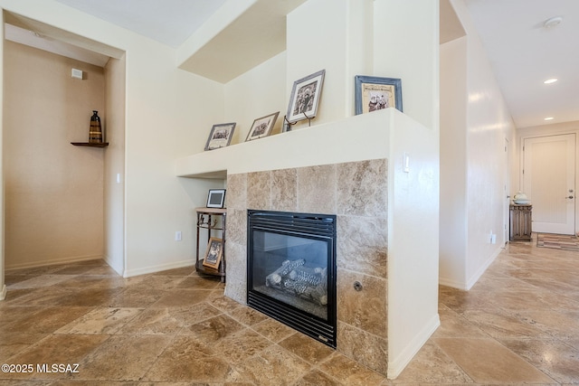 interior details featuring a tile fireplace