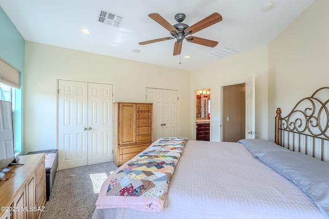 bedroom featuring multiple closets, carpet floors, connected bathroom, and ceiling fan